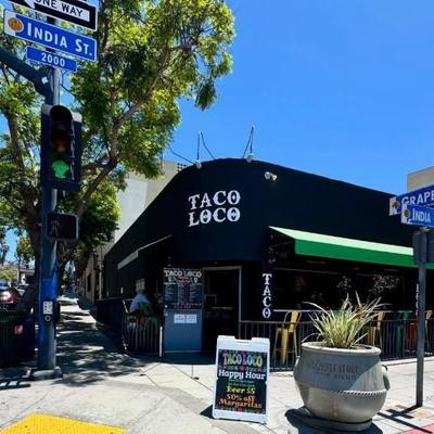 Black building with green awning with Taco Loco on it..