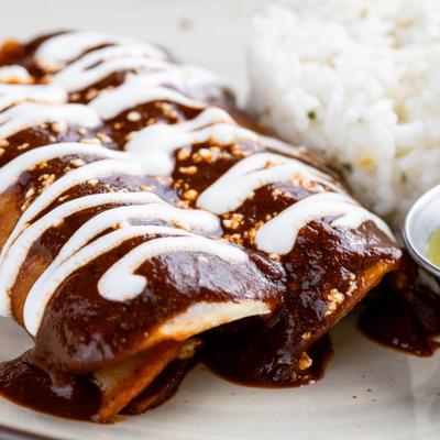 Enchiladas in mole sauce rice.