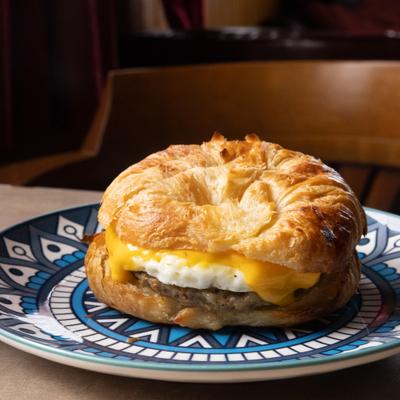 Breakfast croissant sandwich with sausage patty, egg and cheese.