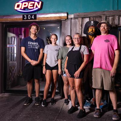 The staff standing outside of the restaurant.