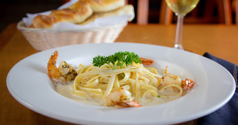 Shrimp and pasta with a sauce,  served