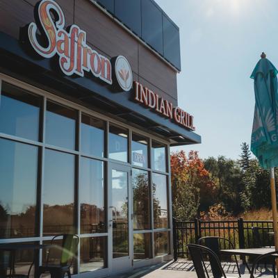 Side view at the restaurant's entrance with the sign above it.