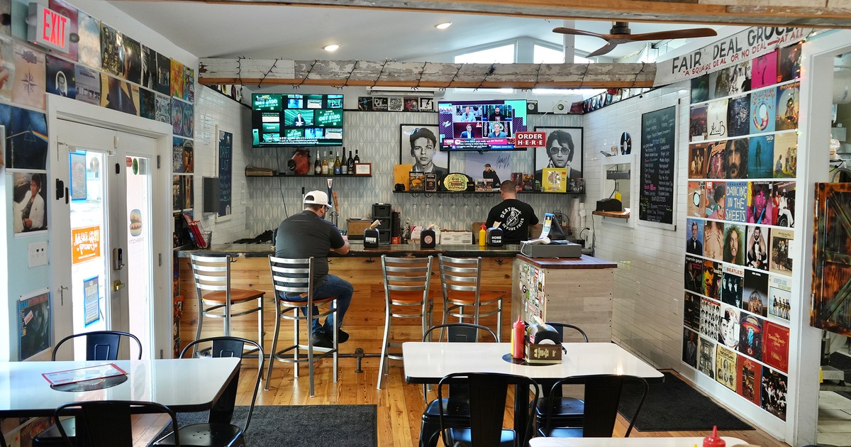 Interior dining area and bar area decorated with old album covers
