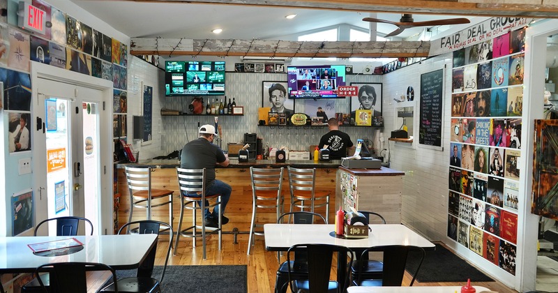 Interior dining area and bar area decorated with old album covers