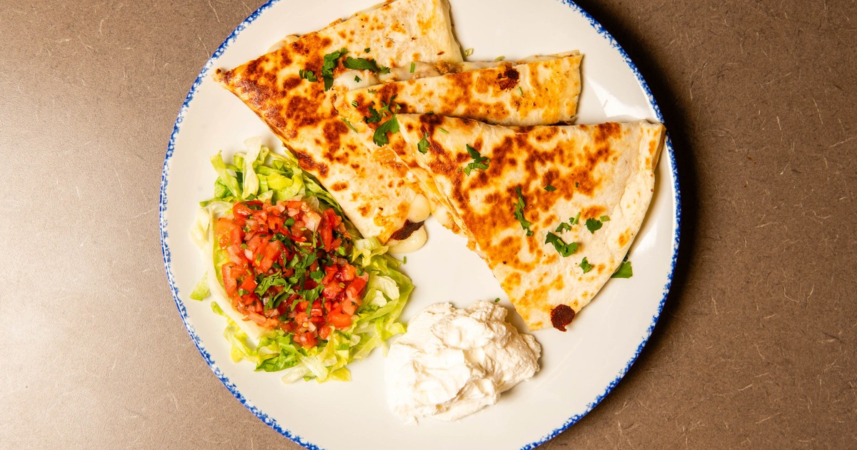 Chicken Quesadilla served woth a salad and sour creme, top veiw