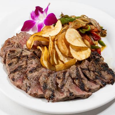 Black Angus Boneless Shell Steak, served with chips and sauteed vegetables.