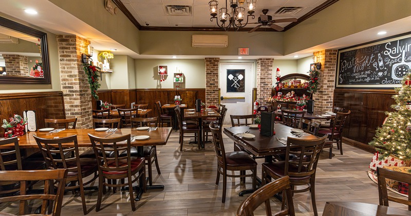 Restaurant interior, dining area with set tables, Christmas decoration details