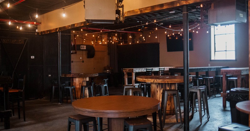 Interior, tables of various shapes, bar stools and chairs