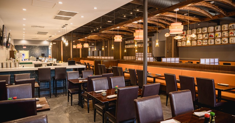 Interior, dining area, wooden top tables for four, bar in the back, tile flooring
