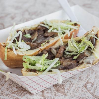 Steak sandwich, with shredded lettuce.