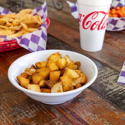 Smothered Taters served with othed dishes and adrink.