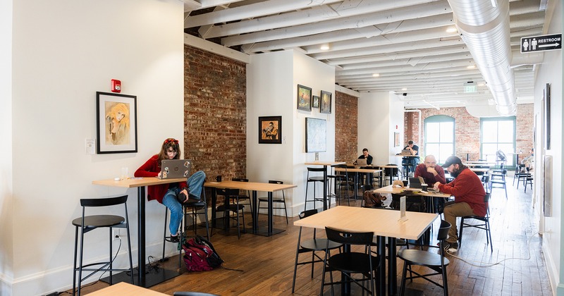 Interior, upstairs seating area, guests chatting, using their laptops