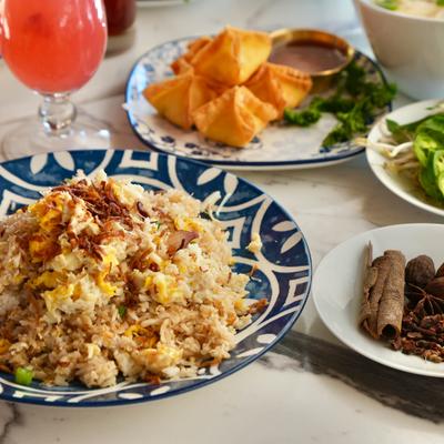 Variety of menu items served on the table with a drink.