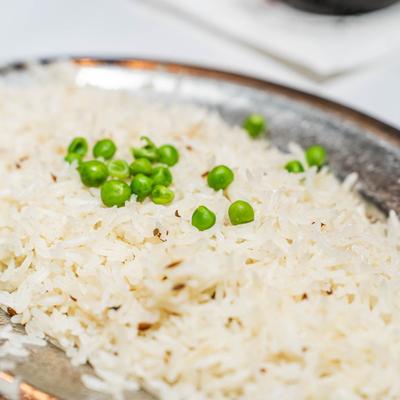 Basmati rice garnished with green peas.
