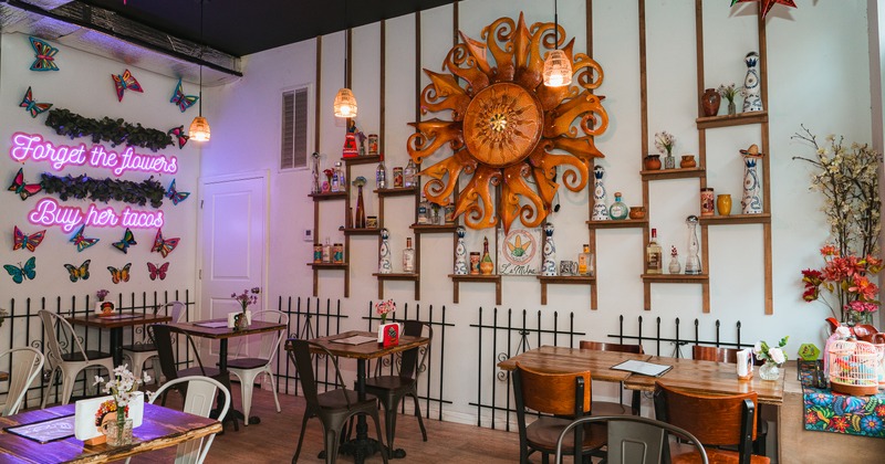 Diner area, tables, chairs, decorated wall, wide view