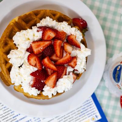 Waffle with strawberries and cream.