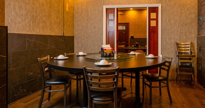 Interior, private dining area, round table with lazy Susan, wooden flooring