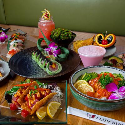 Assorted food plates and drinks spread on a table.