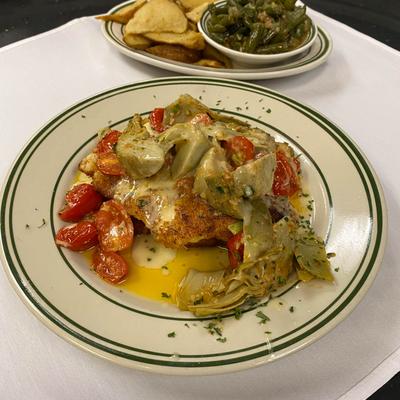 Chicken Biloxi -pan fried chicken breast topped with artichokes, grape tomatoes, beurre blanc sauce.