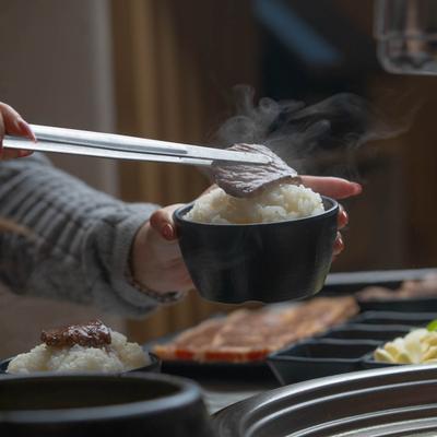Hands serving up a meal.