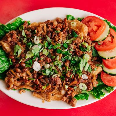 Fried fish fillet, with ginger sauce, soybeans, ground pork, scallions, tomato, cucumber, and rice.