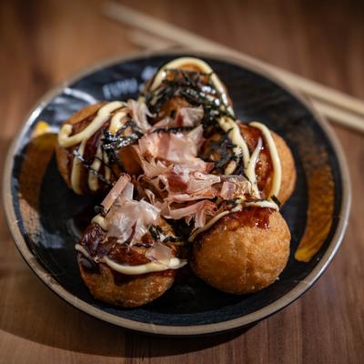 Japanese octopus balls topped with fish flakes and seaweed.