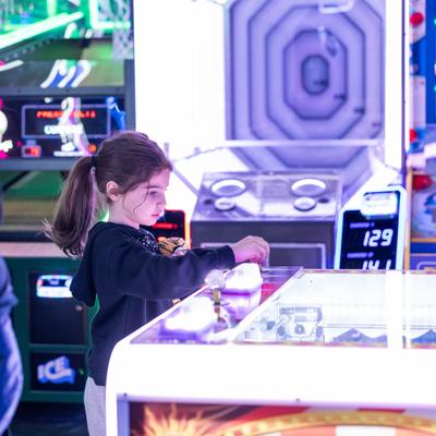 A child playing an arcade game.