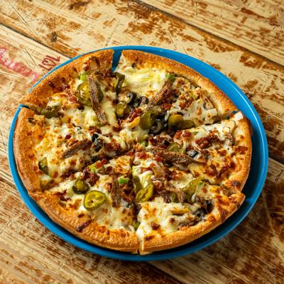 Pizza topped with beef, sausage, bacon, olives, and jalapenos.