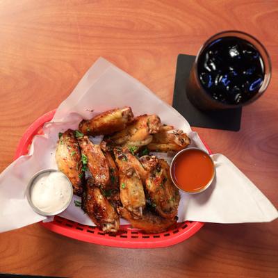 Buffalo chicken wings and a drink.