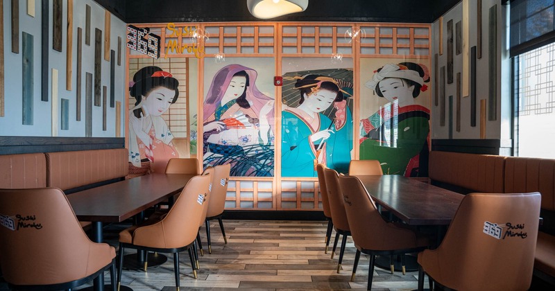 Interior, banquette seating with long dining tables and chairs