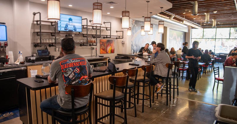 Interior, guests sitting at the bar