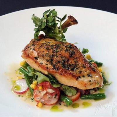 Herb-roasted chicken breast with vegetables.