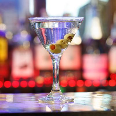 Martini cocktail garnished with oloves.