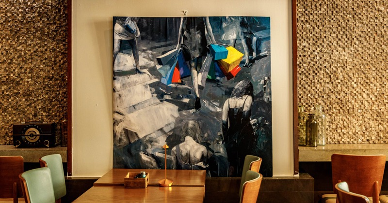 Table for four next to a wall with a painting