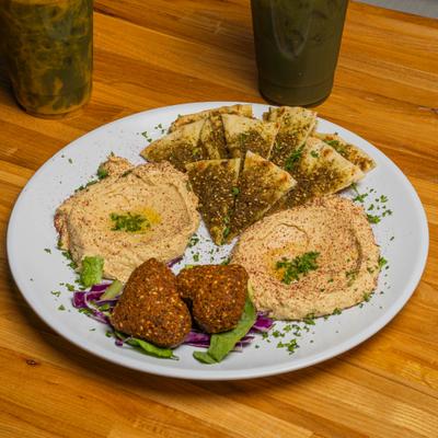 Hummus served with toasted pita triangles and hart-shaped falafel.