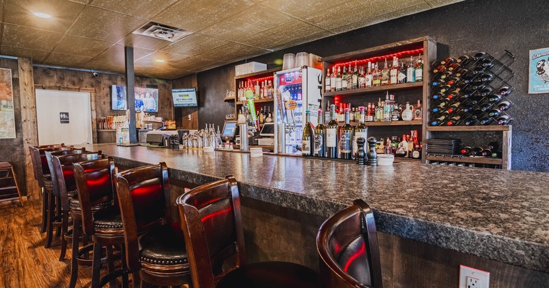 Interior, bar area, neatly lined up bar stools