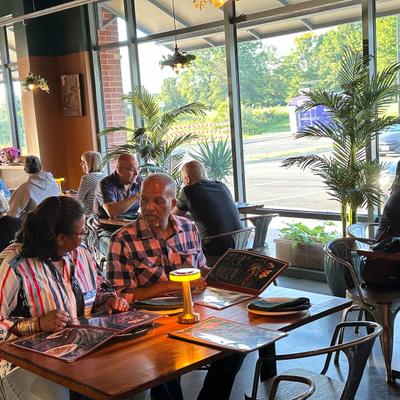 People seating at the table, looking at menus.