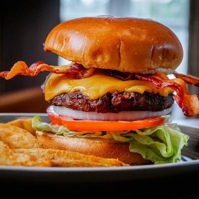 Cheeseburger with bacon, served with fries.