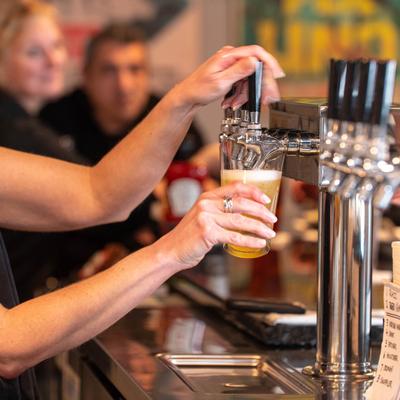 Bartender pouring beer from the tap.