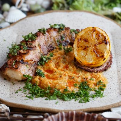 grilled octopus with ajar sauce roasted red pepper garlic.