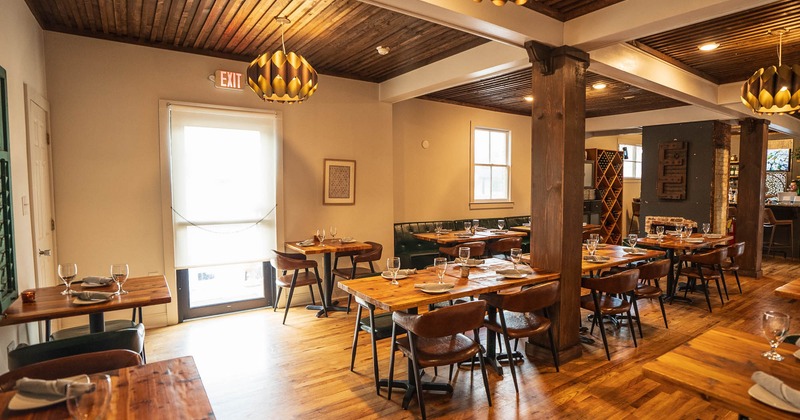 Interior, dining area, wooden tables and chairs, large exposed wooden beams