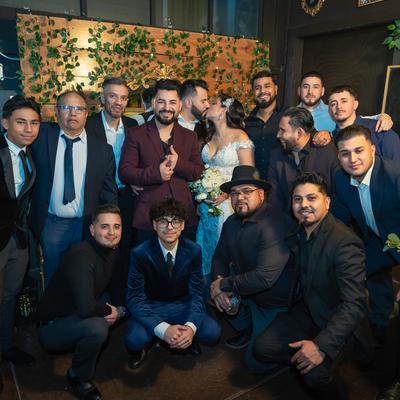 Newlyweds posing for a picture with groomsmen