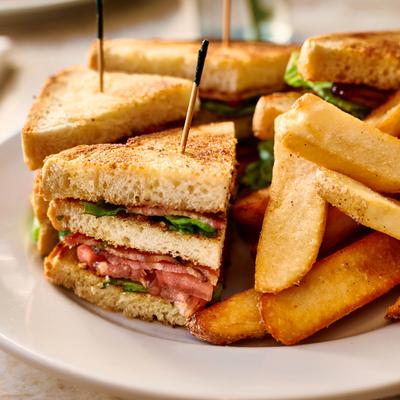 Club sandwich served with thick-cut fries.