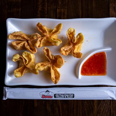 Crab Rangoon served with sweet chili sauce.
