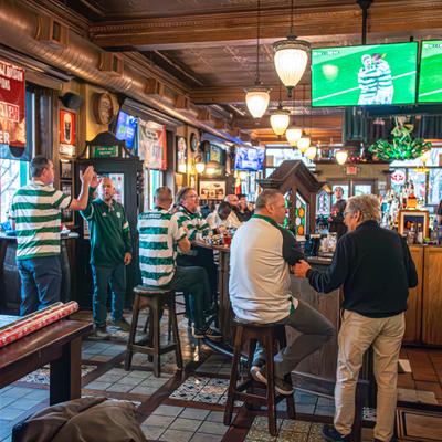Interior with people watching spors in the bar area.