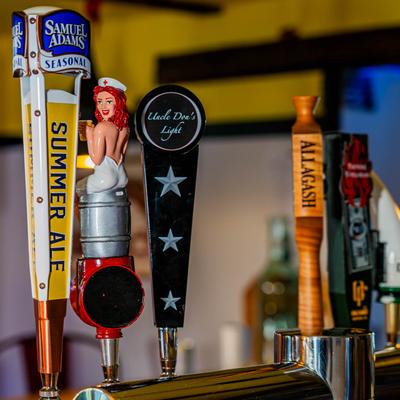 Assorted beer tap handles.