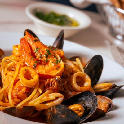 Close-up of seafood pasta in a spicy marinara sauce.