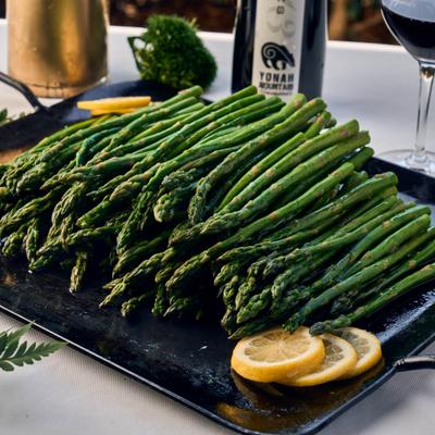 Grilled asparagus spears topped with lemon zest.