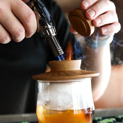 Smoked Old Fashioned preparation.