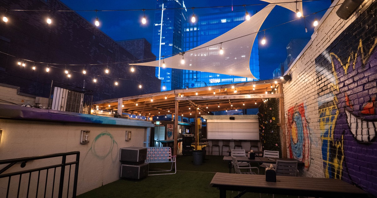 Exterior, Mario' s pizza rooftop, partially covered seating area, artificial grass carpeting